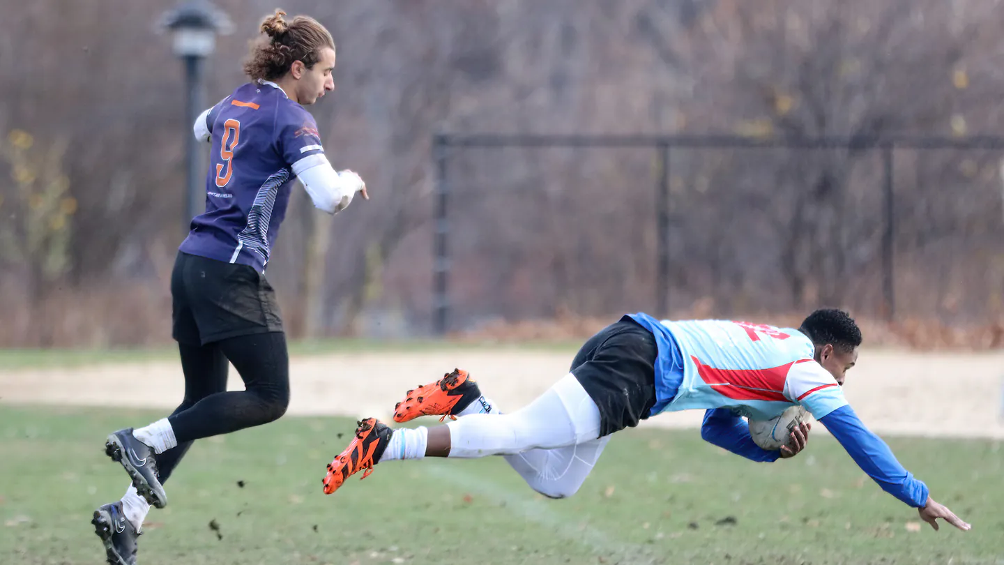 A rugby player diving across the try line at New York Rugby Sevens